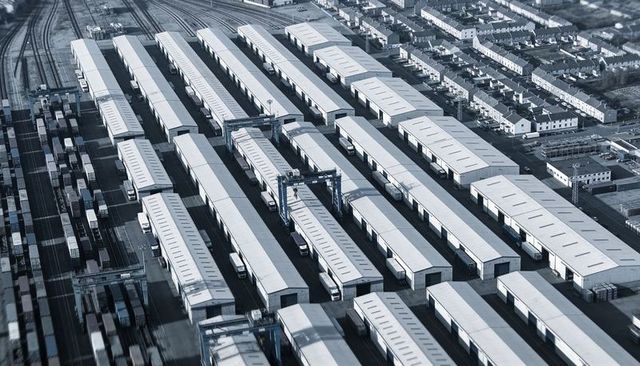 Aerial view of intermodal freight terminal with parallel container bays and gantry cranes