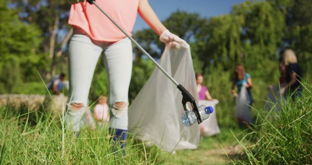 Group of volunteers collecting plastic trash in a park, emphasizing community service, teamwork, and sustainability. Suitable for promoting environmental awareness campaigns, illustrating community initiatives, or highlighting volunteer events.