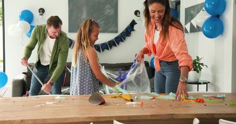 Happy Family Cleaning After Birthday Celebration
