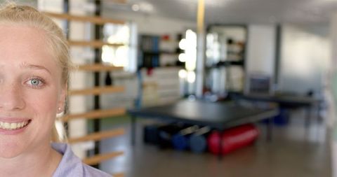 Smiling Woman in Rehabilitation Center with Exercise Equipment Background - Download Free Stock Images Pikwizard.com