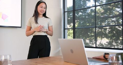 Businesswoman Presenting in Modern Office Environment