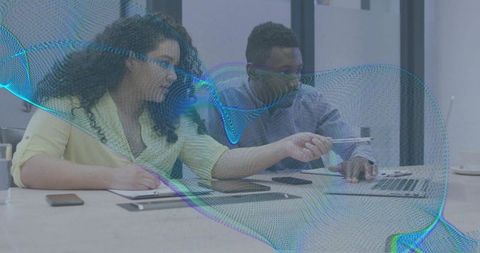 Team collaborating at laptop with digital mesh overlay illustrating data collaboration