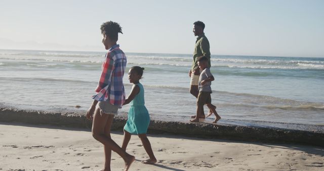 Happy Family Walking on Sandy Beach During Sunny Day - Download Free Stock Images Pikwizard.com