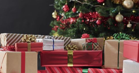 Festive christmas gifts under decorated holiday tree