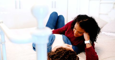 Lesbian Couple Relaxing Together on Cozy Bed at Home