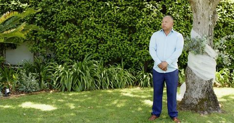 Senior Man Waiting with Anticipation for Wedding Ceremony in Garden
