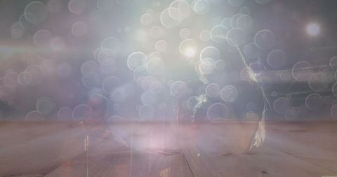 Dreamlike duo performing on wooden stage with bokeh lights and retro microphone