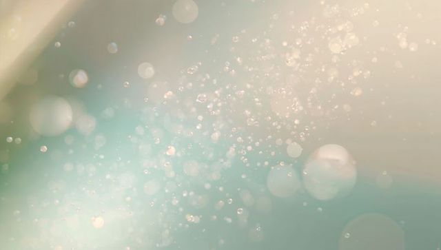 Pastel bokeh light particles floating in soft glow abstract for web design, branding
