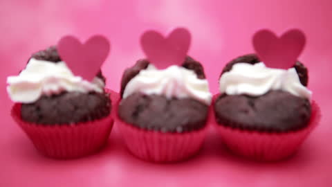 Valentine's Cupcakes with Heart Toppers in Pink Setting