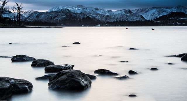 Serene Winter Landscape with Snow-capped Mountains and Calm Lake - Download Free Stock Photos Pikwizard.com