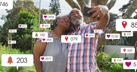 Seniors taking selfie in backyard garden with social media notifications and like icons