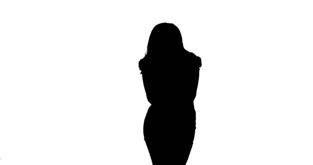 Silhouette of woman standing alone against white background highlights her form and posture. Great for concepts representing independence, mystery, isolation, or background for design projects due to the high contrast.