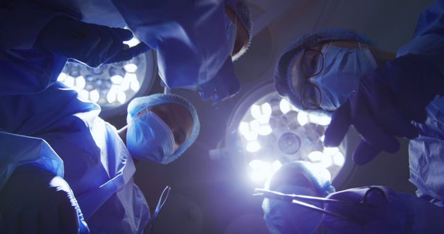 Surgeons Performing Operation in Surgical Theater with Intense Lighting - Download Free Stock Images Pikwizard.com