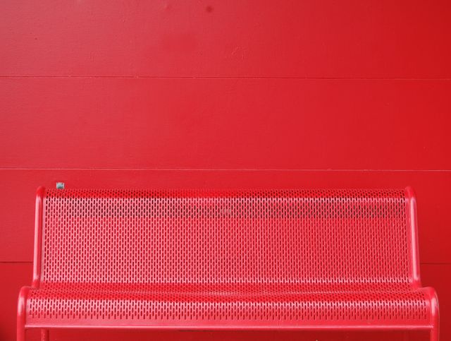 Red Urban Metal Bench Against Red Wall - Download Free Stock Photos Pikwizard.com
