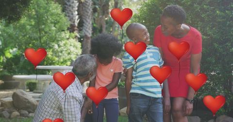 Heart Balloons Over Joyful African American Family Outdoors