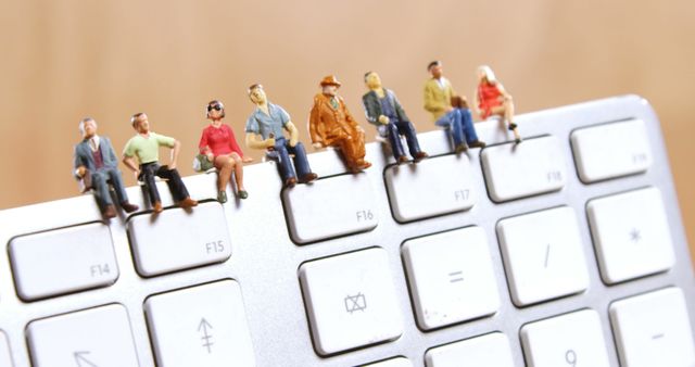 Miniature Diverse Figures Interacting with Technology on Keyboard - Download Free Stock Images Pikwizard.com