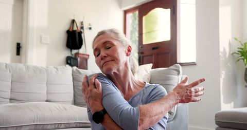 Senior Woman Stretching at Home Embracing Relaxed Lifestyle