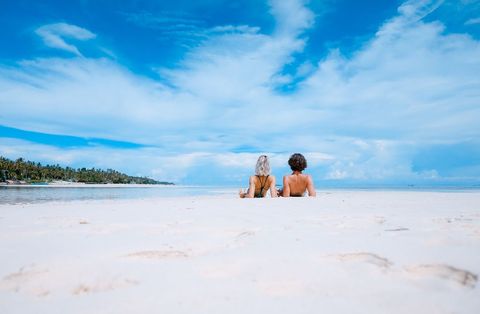 Couple Relaxing on Sunny Tropical Beach