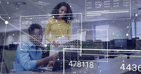 IT Professionals Analyzing Network Data in Modern Office Environment