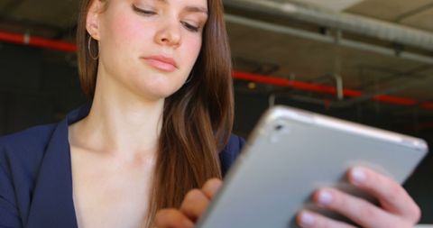 Focused Businesswoman Using Tablet in Modern Office Environment