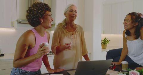 Multigenerational women planning wedding together in modern kitchen