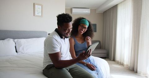 Happy Couple Celebrating Pregnancy via Video Call at Home