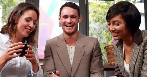 Joyful Group of Friends Enjoying Coffee and Laughter