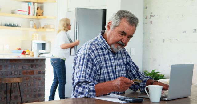 Senior Man Shopping Online with Credit Card in Modern Kitchen - Download Free Stock Images Pikwizard.com