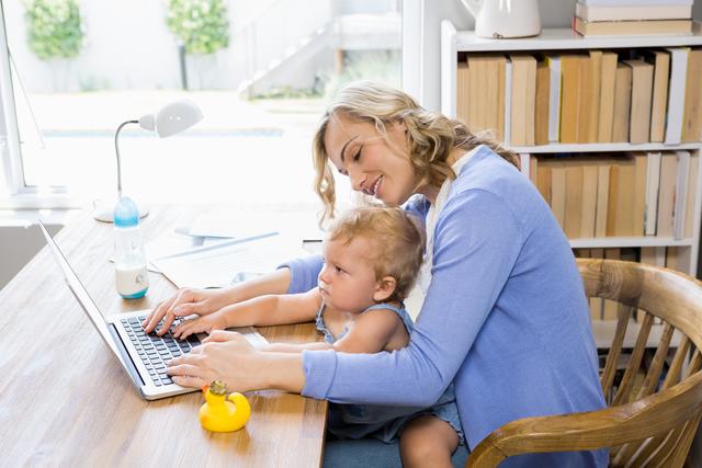 Mother Working from Home with Baby on Lap - Download Free Stock Photos Pikwizard.com