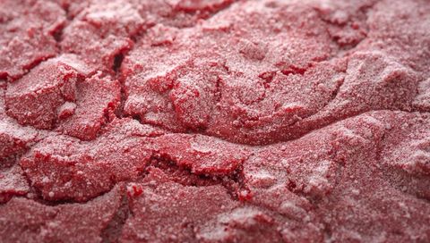 Macro red sorbet texture with frost crystals and sugar dusting for food design