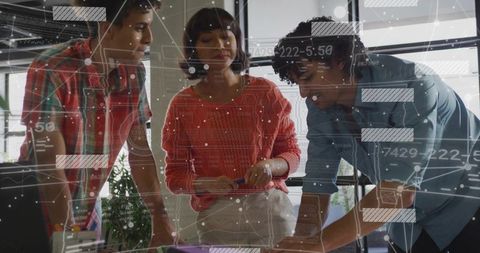 Team collaborating on data-driven planning with digital overlays in modern coworking space