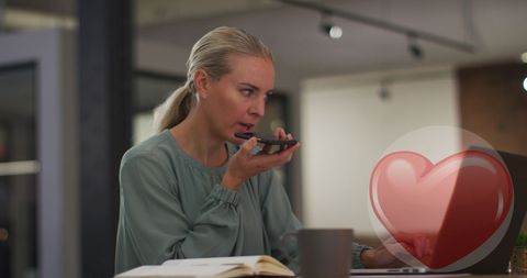 Businesswoman Using Smartphone with Digital Heart Graphics