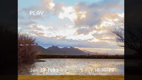 Time-Lapse Clouds Above Serene Mountain Lake with Glitch Effect