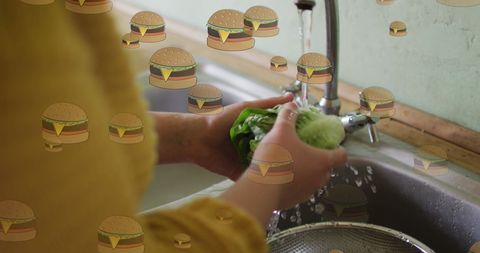 Digital influence: hamburger icons over woman washing vegetables
