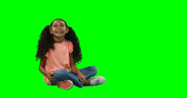 Happy Little Girl with Long Hair Sitting Against Green Background - Download Free Stock Images Pikwizard.com