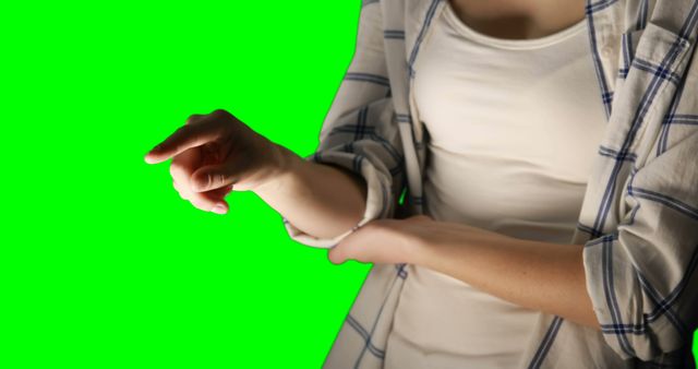 Mid section of woman using invisible screen against green screen