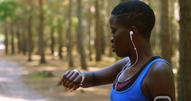 Female Running Jogger Tracking Time with Smartwatch in Forest - Download Free Stock Images Pikwizard.com