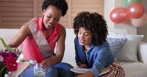 Couple Celebrating at Home with Drinks and Snacks