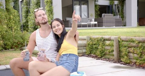 Couple Relaxing Poolside Sharing Refreshing Drinks Moment