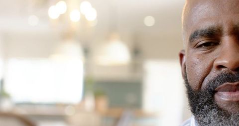 Contemplative mature man in modern minimalistic kitchen