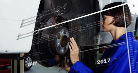 Female Mechanic Inspecting Brake Rotor and Hub with Digital Diagnostics Overlay