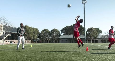 Goalkeeper training: players mastering techniques on soccer field