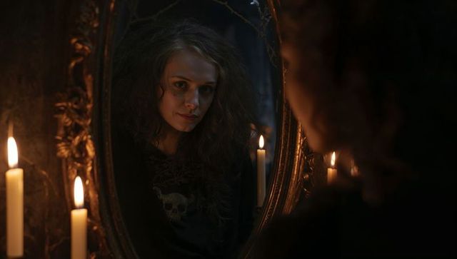 Woman in Gothic Vibes Reflecting by Candlelight