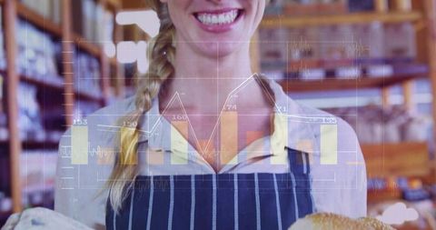 Smiling artisan baker wearing striped apron holding fresh loaves with sales data overlay