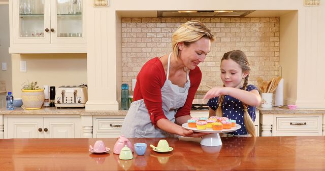 Mother and Daughter Decorating Cupcakes in Kitchen - Download Free Stock Images Pikwizard.com