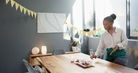 Black Woman Preparing Table for Celebration