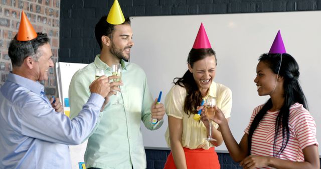 Colleagues Celebrating Office Party with Hats and Drinks - Download Free Stock Images Pikwizard.com