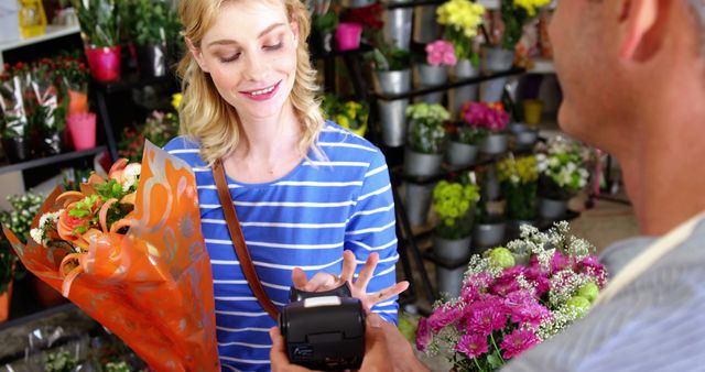 Smiling Woman Paying for Fresh Bouquet at Flower Shop - Download Free Stock Images Pikwizard.com