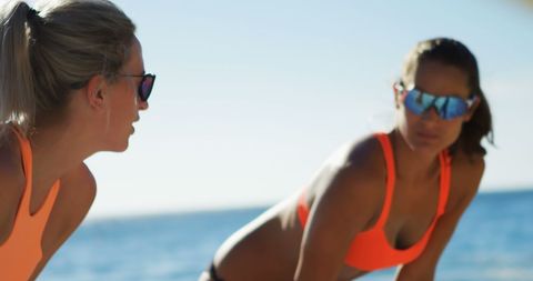 Caucasian Women in Sportswear Exercising by the Beach