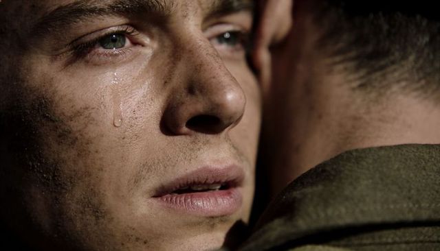 Tear-streaked soldier embracing comrade conveying raw emotion and solidarity